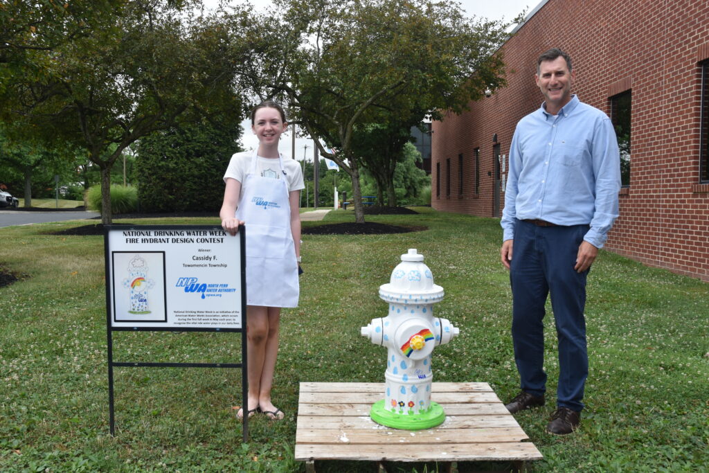 A photo of the contest winner and NPWA's Executive Director with painted hydrant.